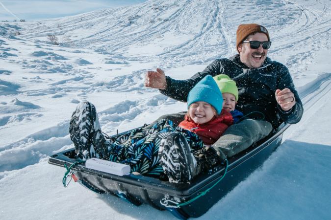 Father Sledding with Two Children