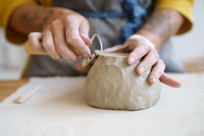 Person Using a Tool on Clay