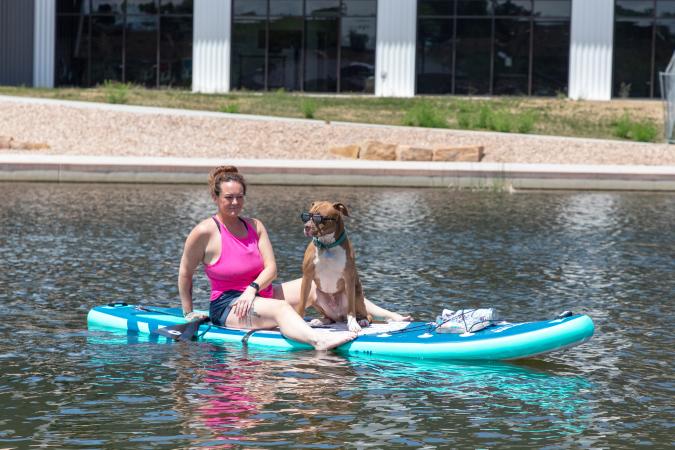 Woman and her dog on a paddleboard on Butterfly Pond