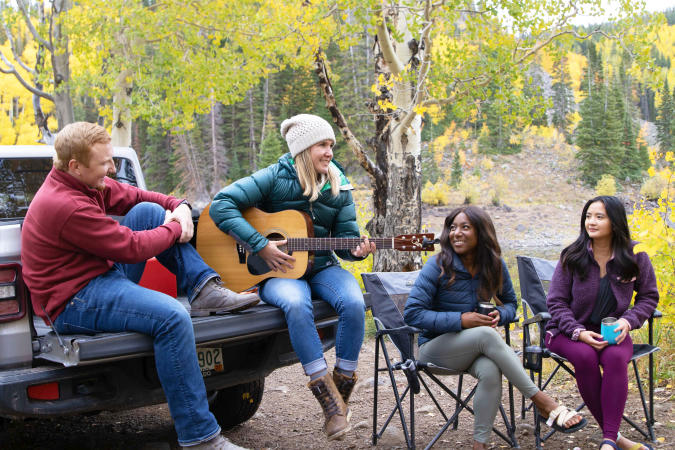 People Surrounded by Fall Colors Tailgating Together