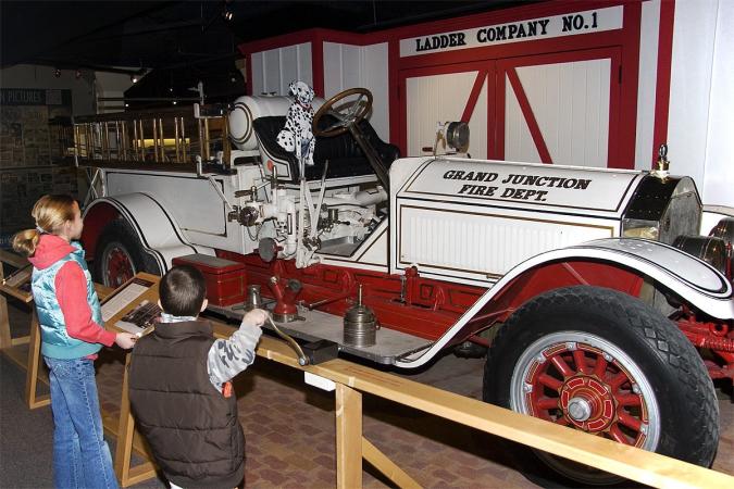 Children looking at fire department display at Museum of the West