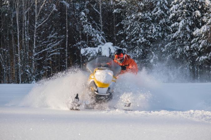 Man Riding a Snowmobile