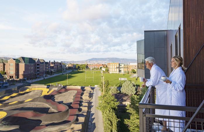 Two People enjoying coffee on Hotel Maverick Balcony