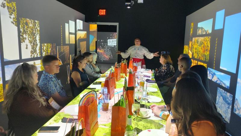 Guests listen to Jason Younis y Delgado speak at a dinner during IMEX America 2024 at Electric Playhouse.