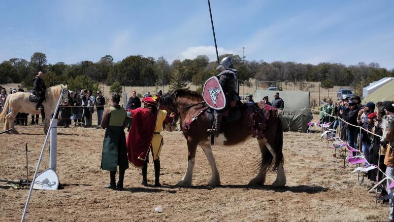 People stand around ahead of a jousting tournament at the New Mexico Renaissance and Celtic Festival