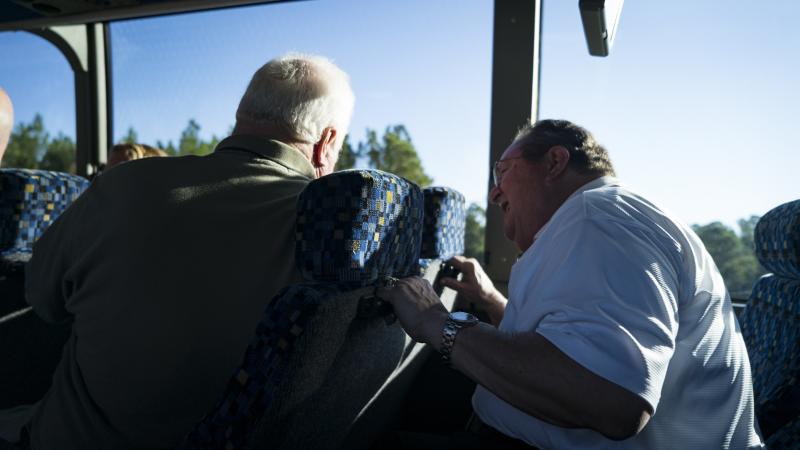 Group travelers socializing inside motorcoach during a group tour trip