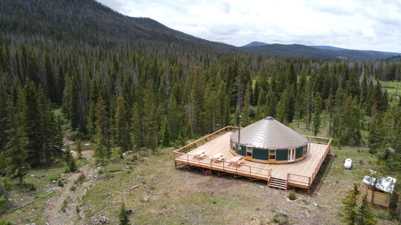 An aerial photo of a yurt in the Rocky Mountains.