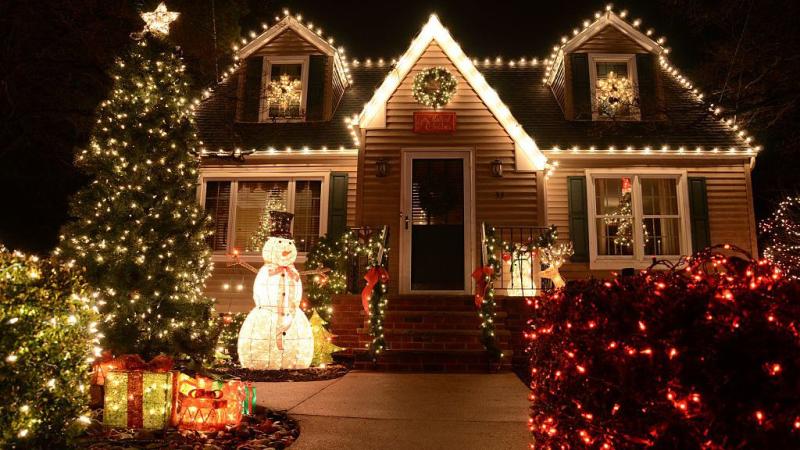 House decorated with Christmas lights and a lighted snowman