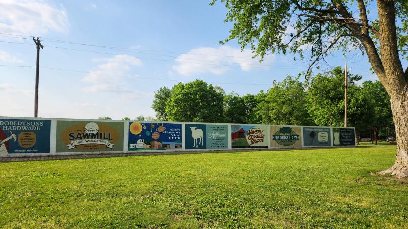 The Historic Mural Wall at Old Town Waverly Park features old fashioned advertisement style murals detailing actual businesses that existed in Morgan County at one time.