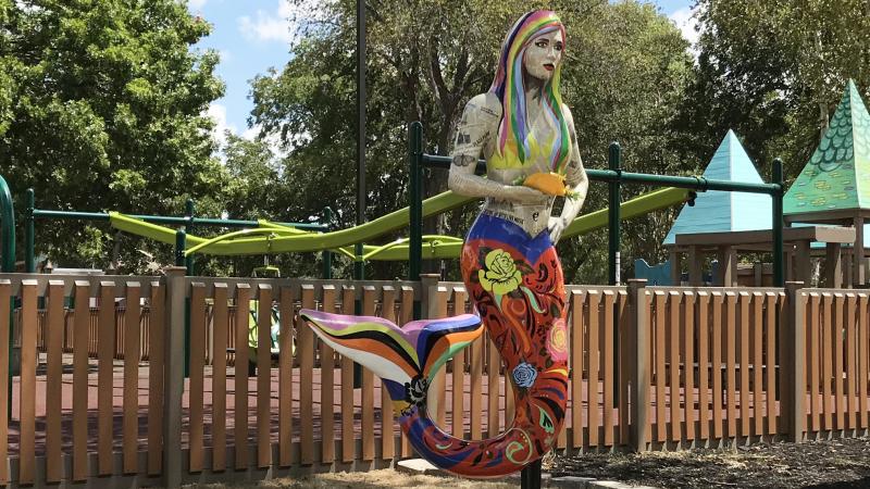 10 foot tall painted mermaid statue with fish taco in hand