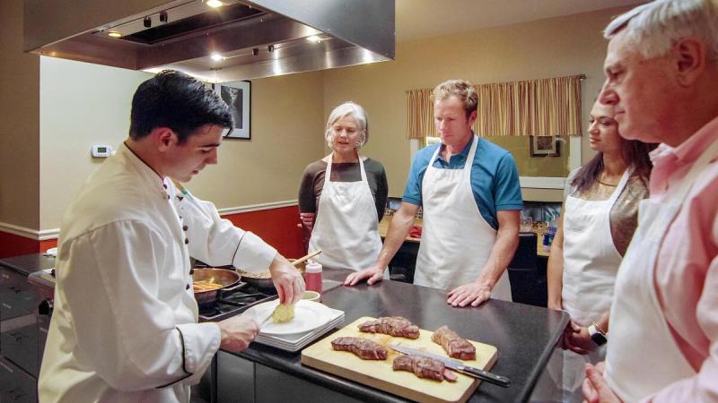 Cooking Classes at the Essex Resort - A family around a kitchen learning to cook new recipes at the Essex Resort & Spa