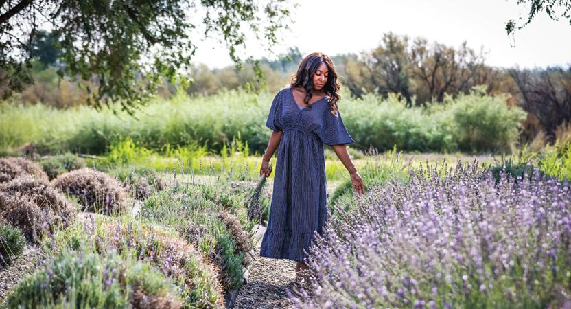 Woman Brushing Hand over Row of Lavender
