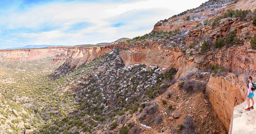 Woman stands at overlook in Colorado National Monument in the Winter