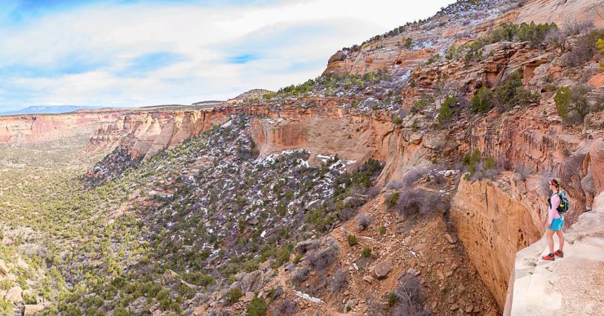 Woman stands at overlook in Colorado National Monument in the Winter
