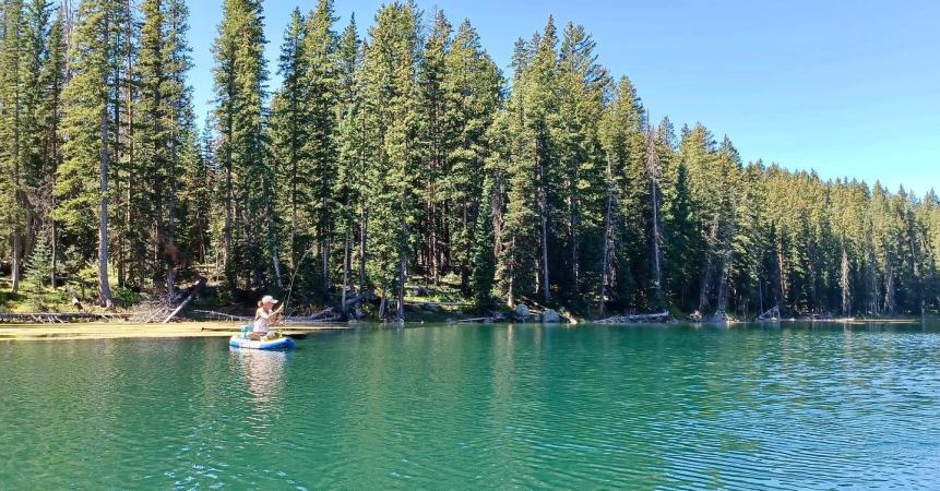 Woman Fly Fishing on a Paddleboard on The Grand Mesa
