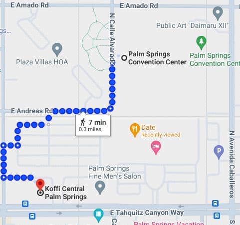 An interactive map displaying a walking route in a city, indicating a 7-minute, 0.3-mile journey with blue dotted lines, from 'Koffi Central Palm Springs', marked with a red pin, to a location tagged with an orange pin labeled 'Recently viewed'. The map includes street names, nearby points of interest, and symbols such as parking and public art.