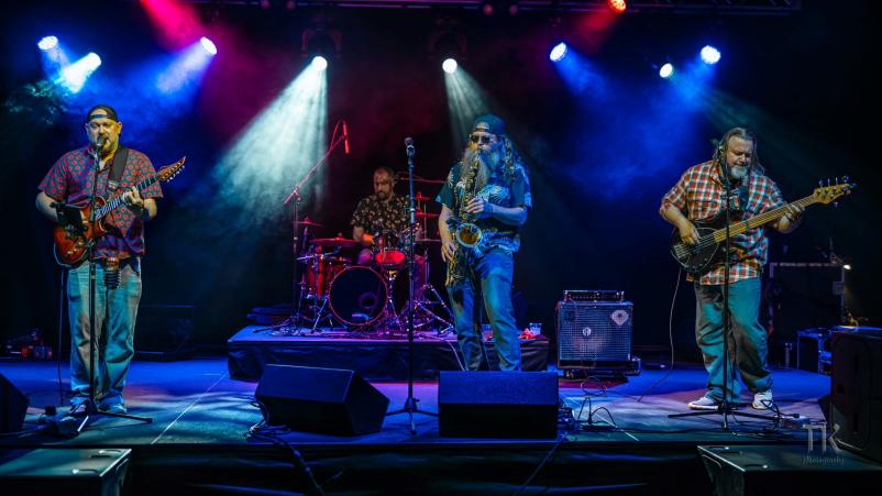 Picture of the band Waupatui playing on stage.