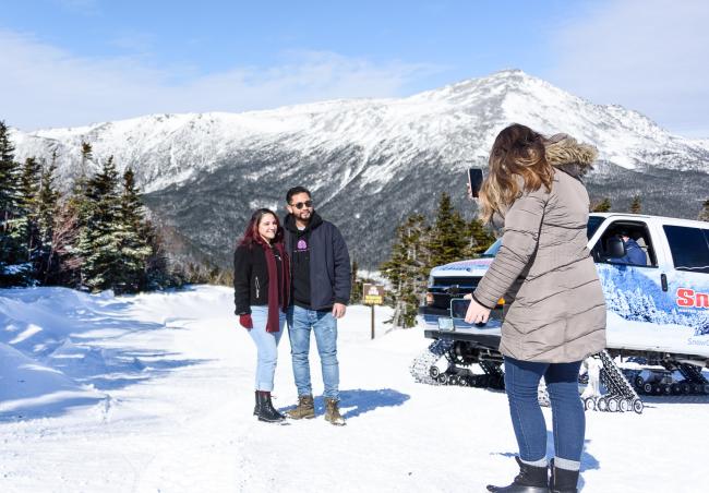 SnowCoach Tour with Couple Taking Photo (Mountains in Background) - Great Glen Trails