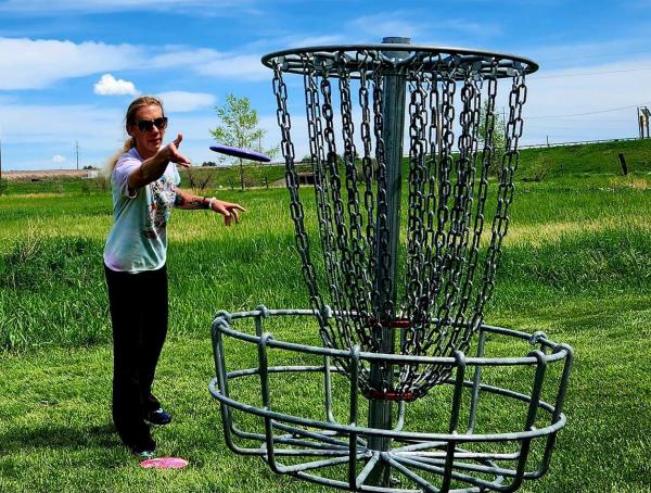 Cheyenne local, Brie, finishes out a hole with an accurate putt on Hole 1 at Clear Creek Disc Golf Course