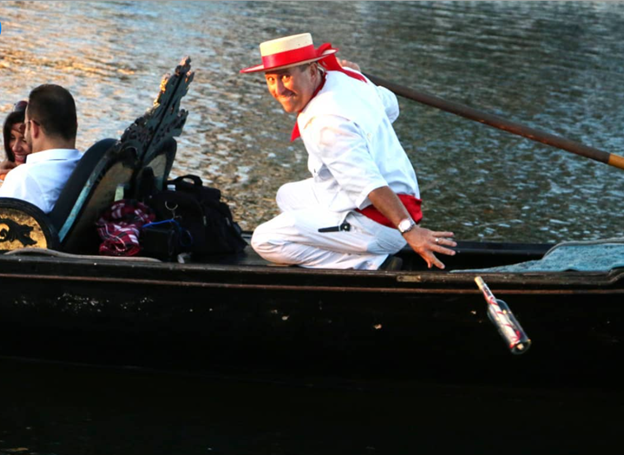 A gondolier drops a message in a bottle during a Gondola Adventures ride in Irving, TX