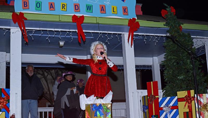 Christmas by the Sea live singer holding a microphone