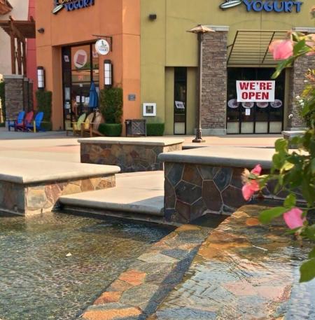 Fountain in front of exterior of yogurt shop