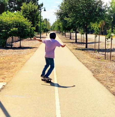 Kid skateboarding along Clovis Trail