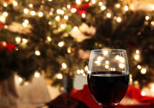 Glass of Red Wine in Front of Christmas Tree