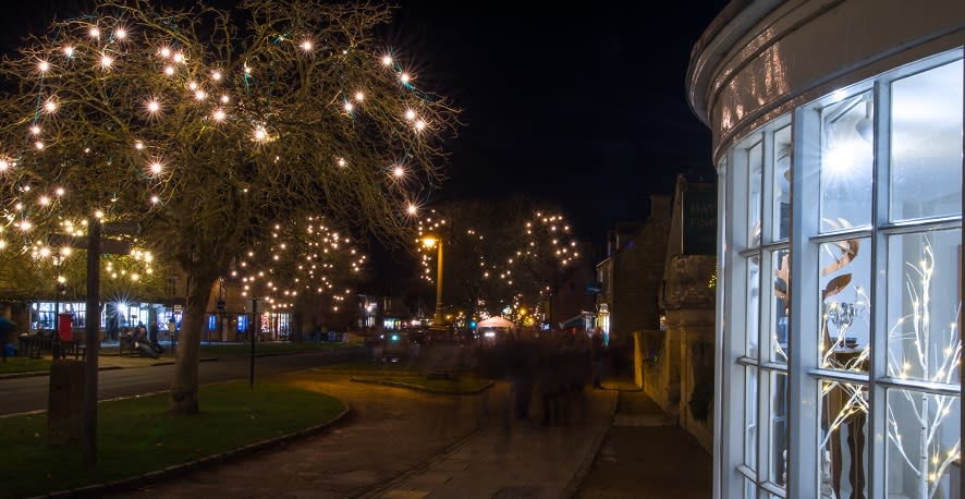 Christmas lights twinkle in the trees along Broadway's High Street