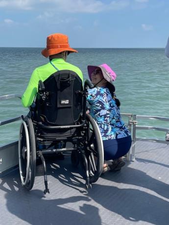 Man in wheelchair enjoying the view of the bay from the ICAN fishing boat