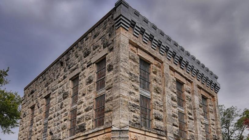 The Gillespie Country Historic Jail with storm clouds overhead