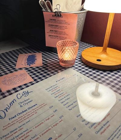 Onion City Chicken & Oyster table with menu and blue plaid tablecloth