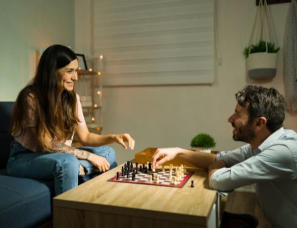 A couple playing chess during a night in.