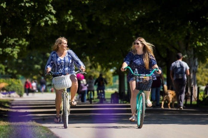 2 women riding bikes