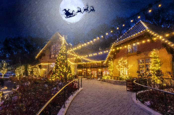 Ruby Falls Plaza is lit up for the holidays-outline of Santa and his sleigh in front of the full moon