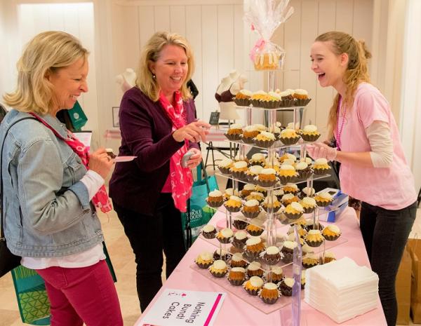 Ladies looking at a tier of cupcakes