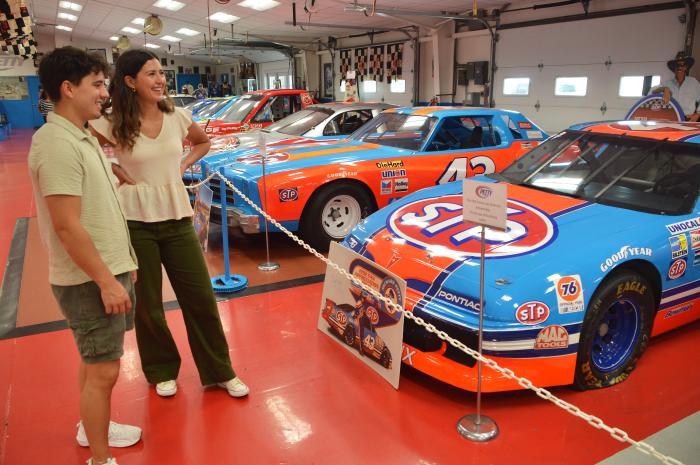 Couple looking at cars on display at the Petty Museum in Randleman, NC