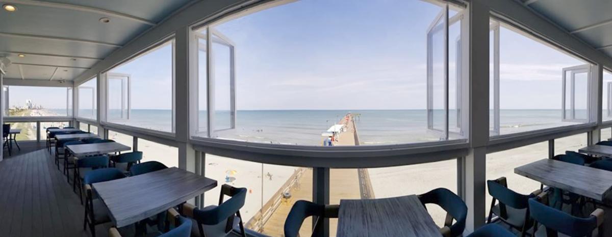 Panoramic view looking out the windows toward the beach from Wicked Tuna at 2nd Avenue Pier