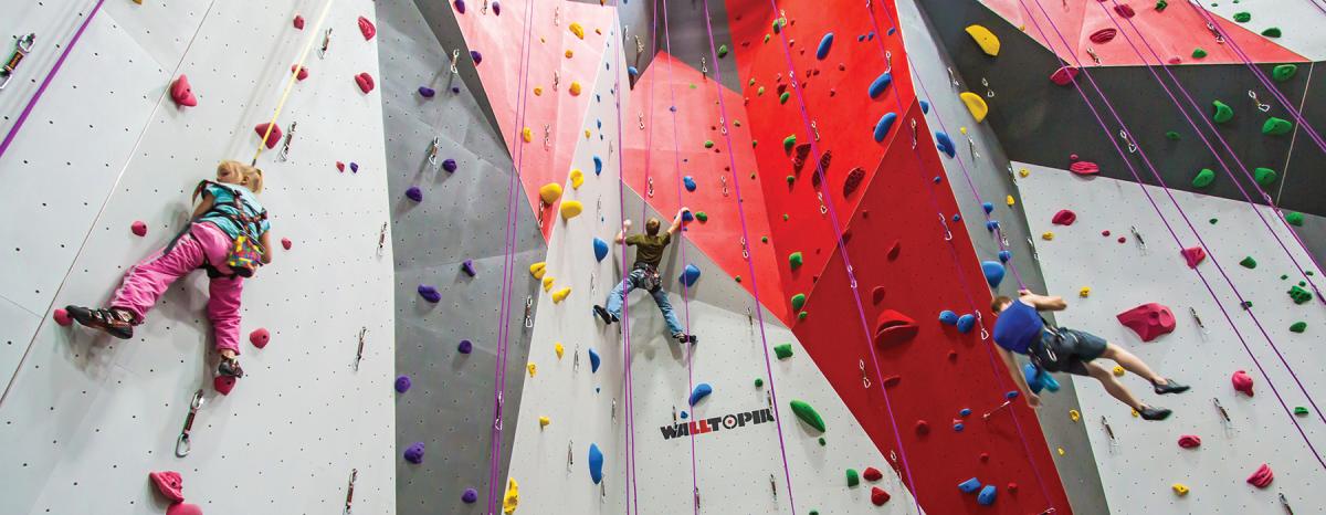 Climbers make their way up and down the wall at Bliss Climbing and Fitness in Wichita, KS.