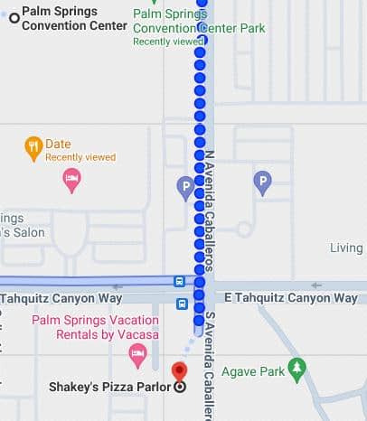 Map screenshot showing a route along North Avenida Caballeros in Palm Springs, with nearby points of interest including Palm Springs Convention Center, Palm Springs Vacation Rentals by Vacasa, Shakey's Pizza Parlor, and Agave Park.