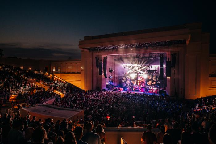 Nighttime concert at an outdoor amphitheater in Huntsville with a large crowd gathered for live music