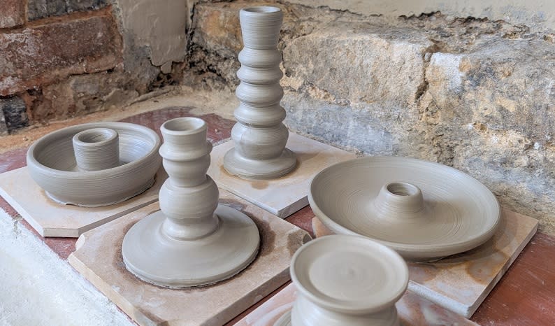 Various types of candelstick drying in the Honeybourne Pottery workshop