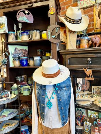 Shopping in Downtown Golden at The Silver Horse. Mugs, art, hats, jewelry, and gifts are on display for sale in the shop.