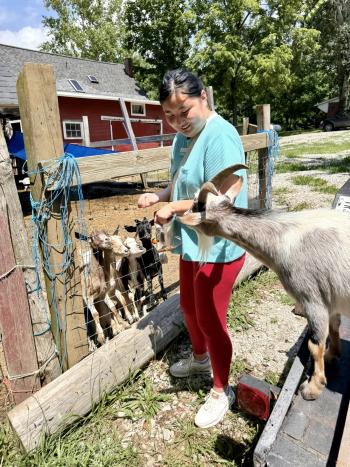 Emma Kocher feeding chickens and goats at the Old 40 Farm