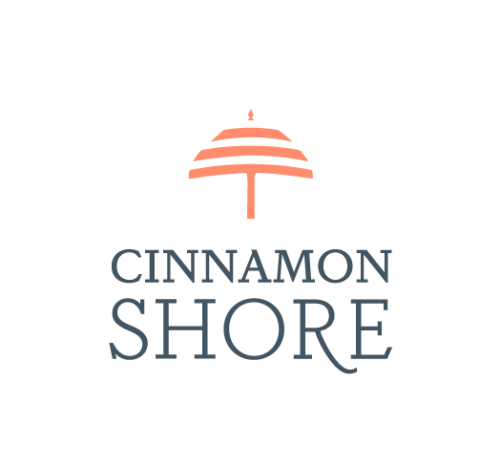 blue text reads Cinnamon Shore. Over top of it is the outline of an umbrella in orange.