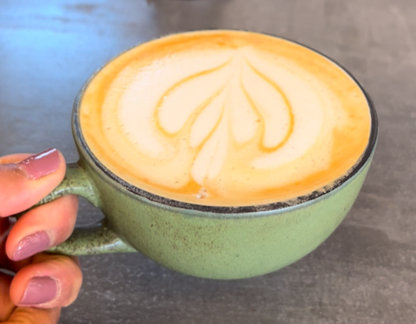 hand holding a mug of coffee