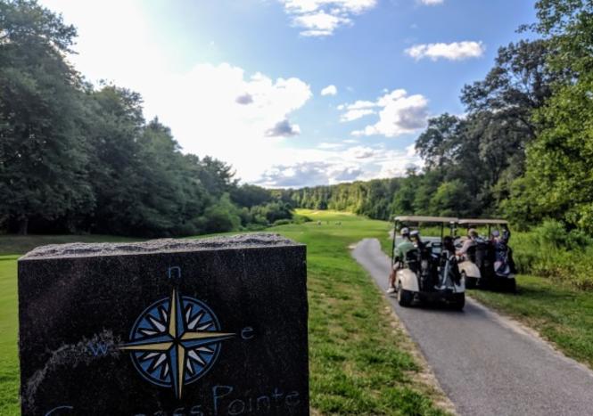 Golf carts along the course at Compass Pointe Golf Course.