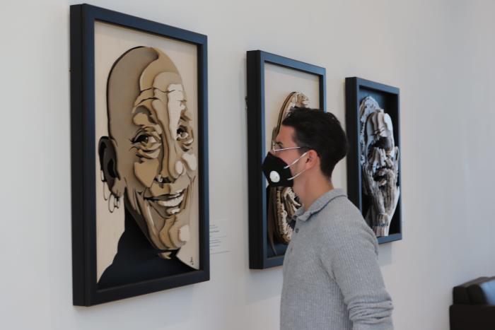 A visitor looking at a piece of artwork at the Columbus Museum of Art