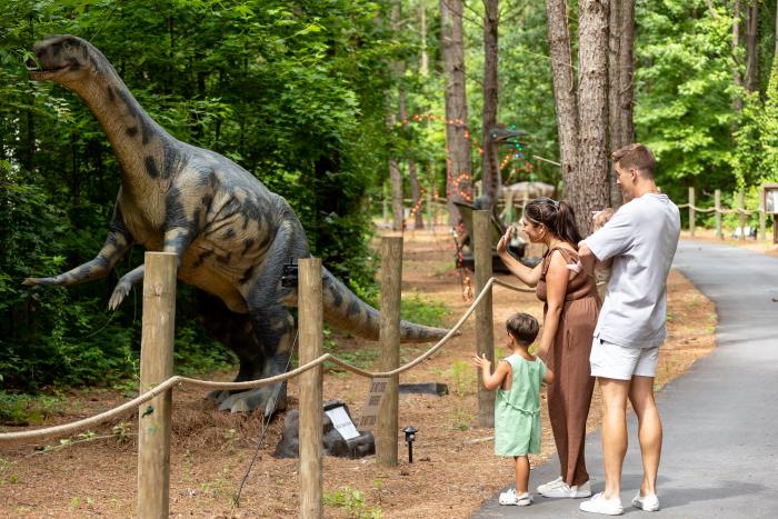 A young family at Cumberland County's Sweet Valley Ranch enjoying the Dino World Trail.