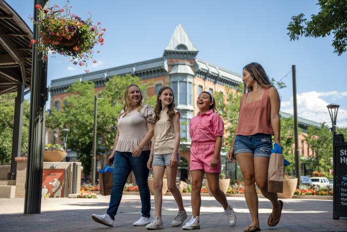 A family does summer shopping at Old Town Square with Linden in the background